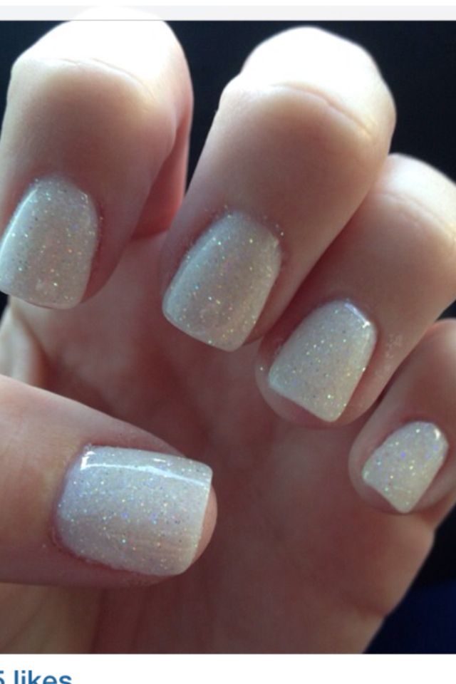 Elegant Sparkling Nail Design with a Delicate White Base and Glamorous Glitter for Any Occasion.