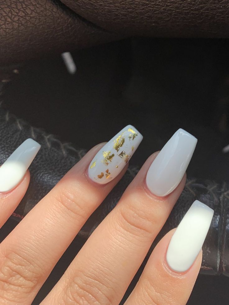 Sleek White Nail Design with Luxurious Gold Flake Accent.