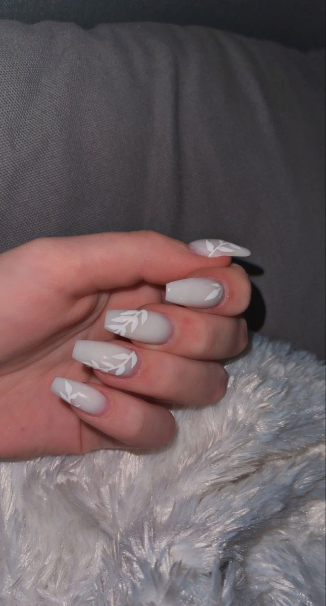 Sophisticated Gray Nail Design with Delicate White Leaf Patterns.