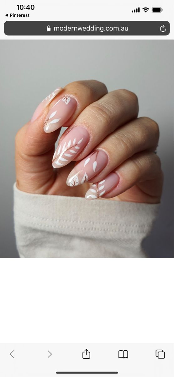 Elegant Soft Pink Nail Design with White Floral Accents.