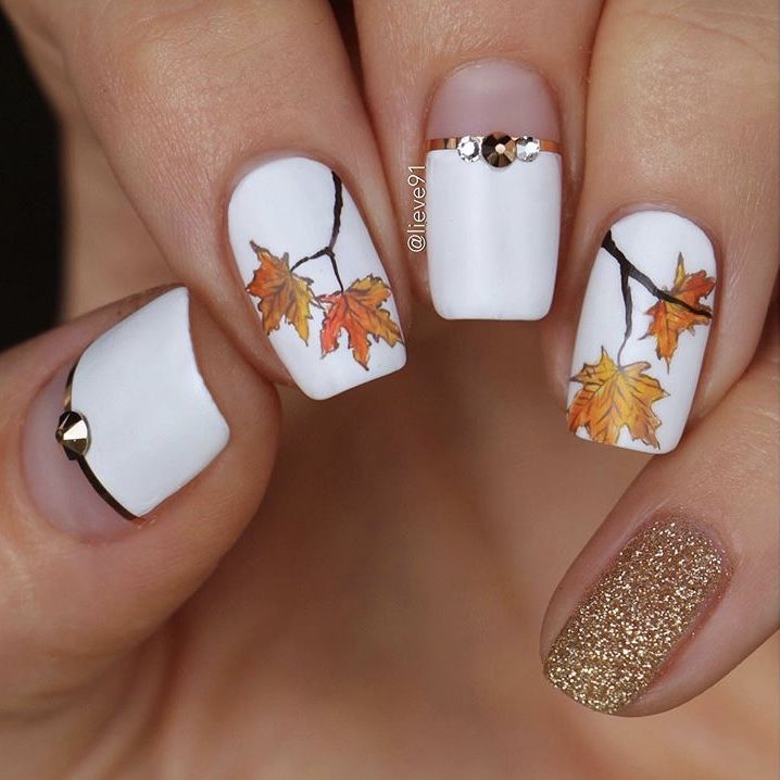 Elegant Autumn Nail Design with White Base, Hand-Painted Leaves, and Gold Accents.