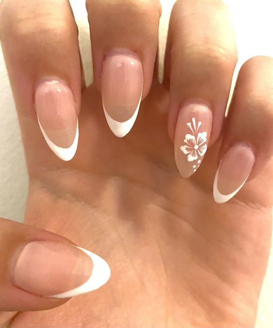 Chic Almond-Shaped French Manicure with Floral Accent: A Modern Twist on Timeless Elegance.