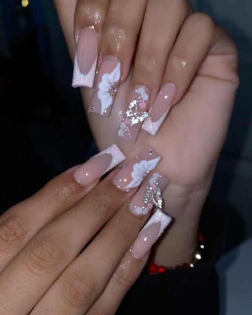 Sophisticated Long Squared Nail Design with Soft Pink and White Floral Accents.