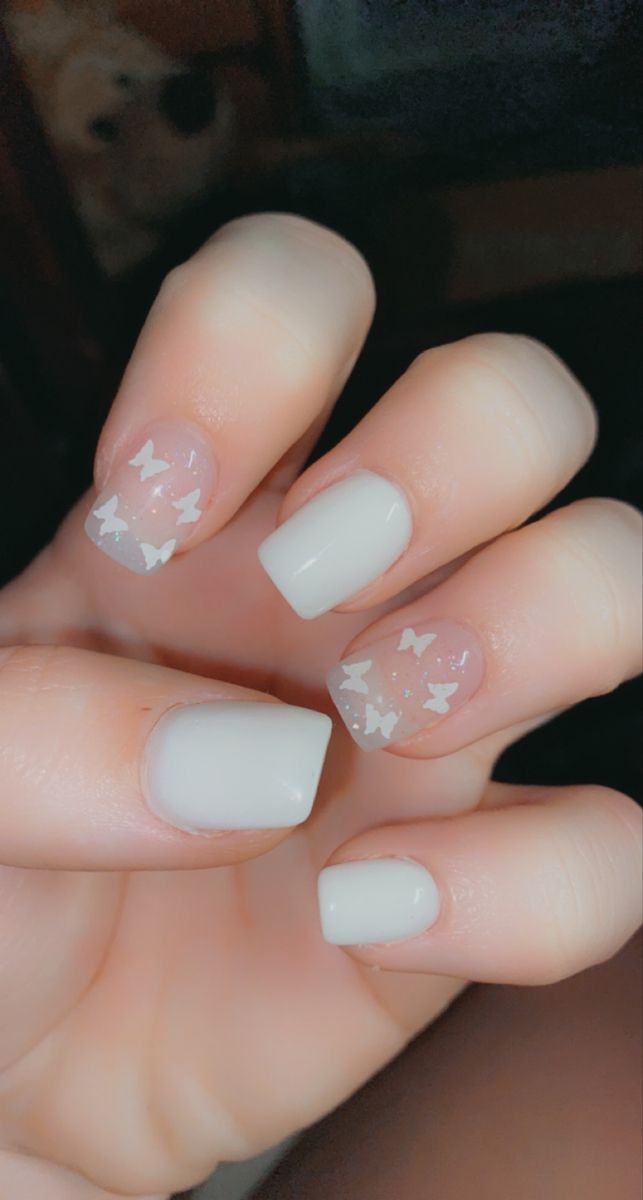 Whimsical Matte White and Clear Nail Design with Butterfly Accents