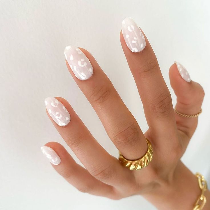 Chic Glossy White Nails with Playful Abstract Patterns for Modern Aesthetics.