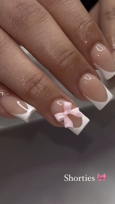 Chic Nail Design: Soft Pink Bow Accented Nude and White French Tips.