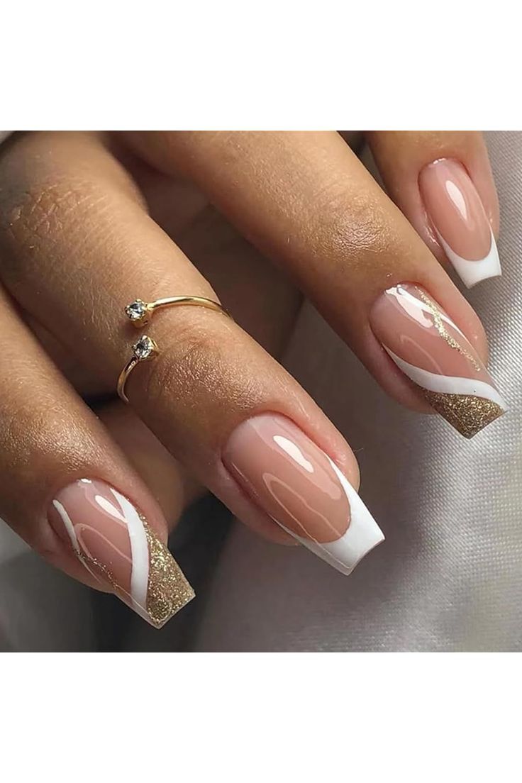 Chic Nude and White Nail Design with Gold Tips and Geometric Patterns.