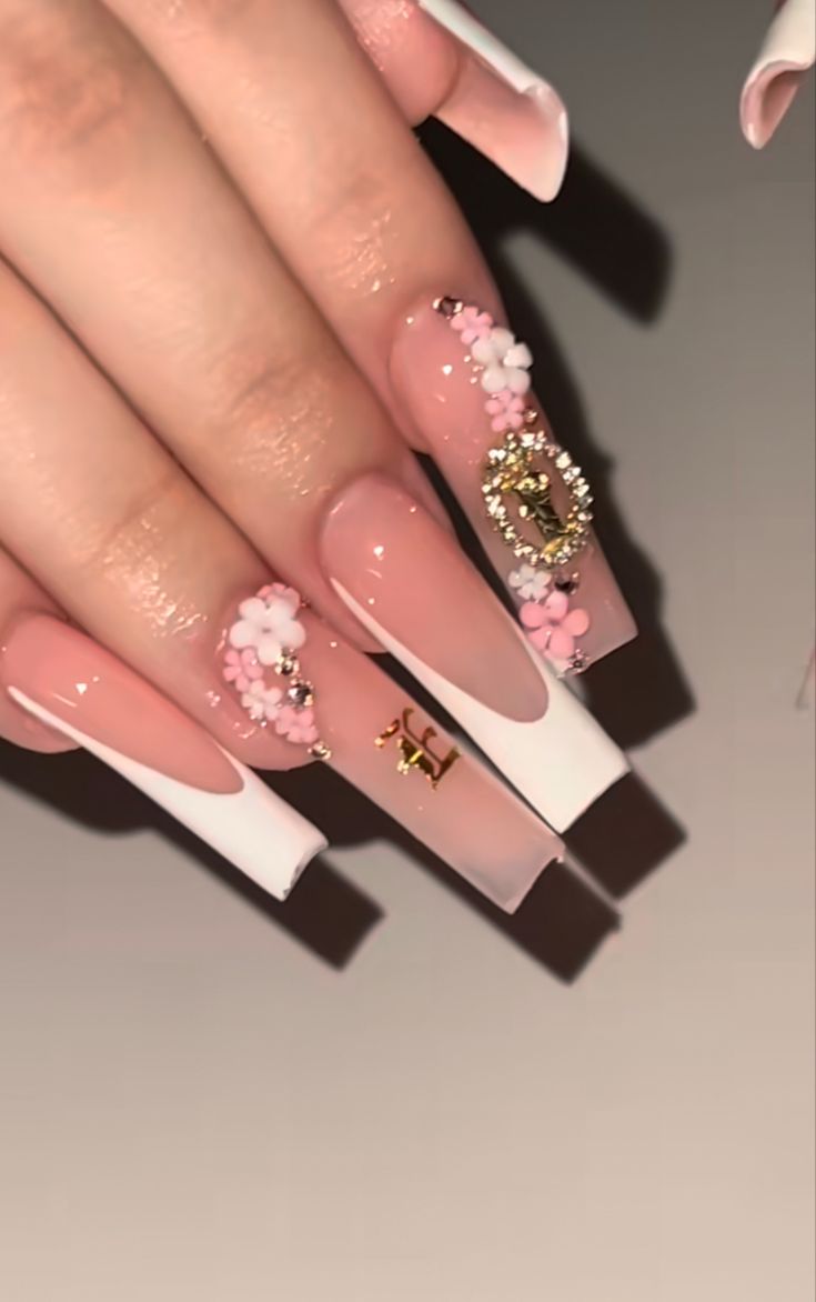 Sophisticated French Manicure with Long Tapered Tips and Delicate Floral Accents.