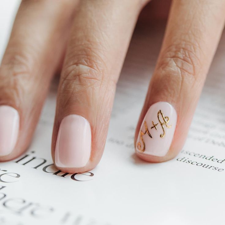 Chic Nude Nail Design with Glossy Finish and Elegant Gold Accent