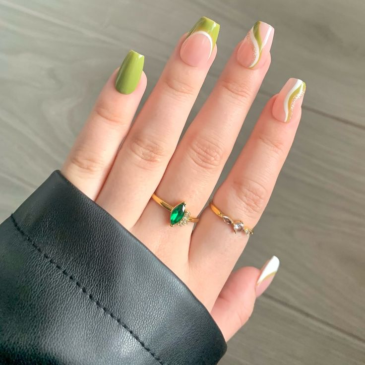 Chic Green and Nude Nail Design with Wavy Accents and Elegant Rings.