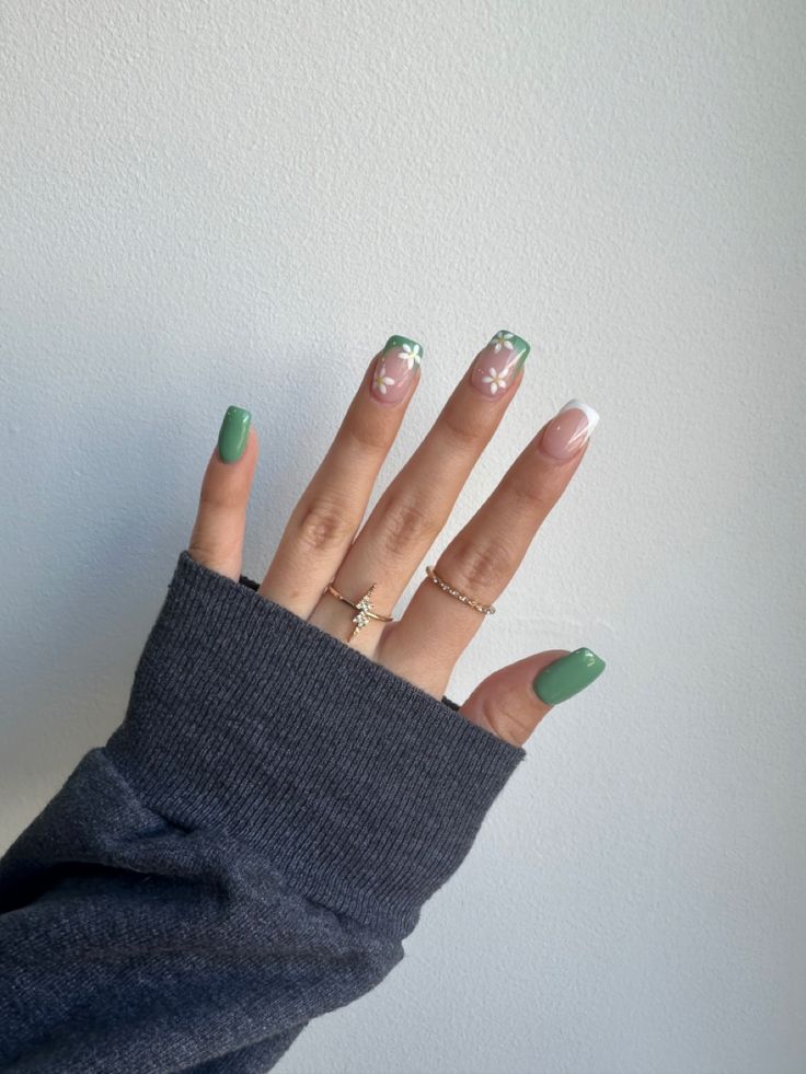 Playful Vibrant Green Nail Design with Floral Accents and Classic French Tips.