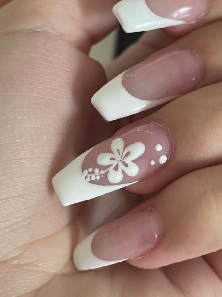 Elegant Floral Nail Design with Delicate White Flower and French Tips on Soft Pink Base.