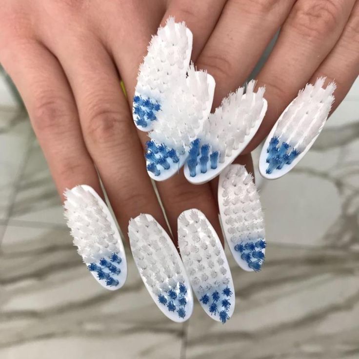 Innovative Textured Nail Art: White Base with Vibrant Blue Accents for a Bold Statement.