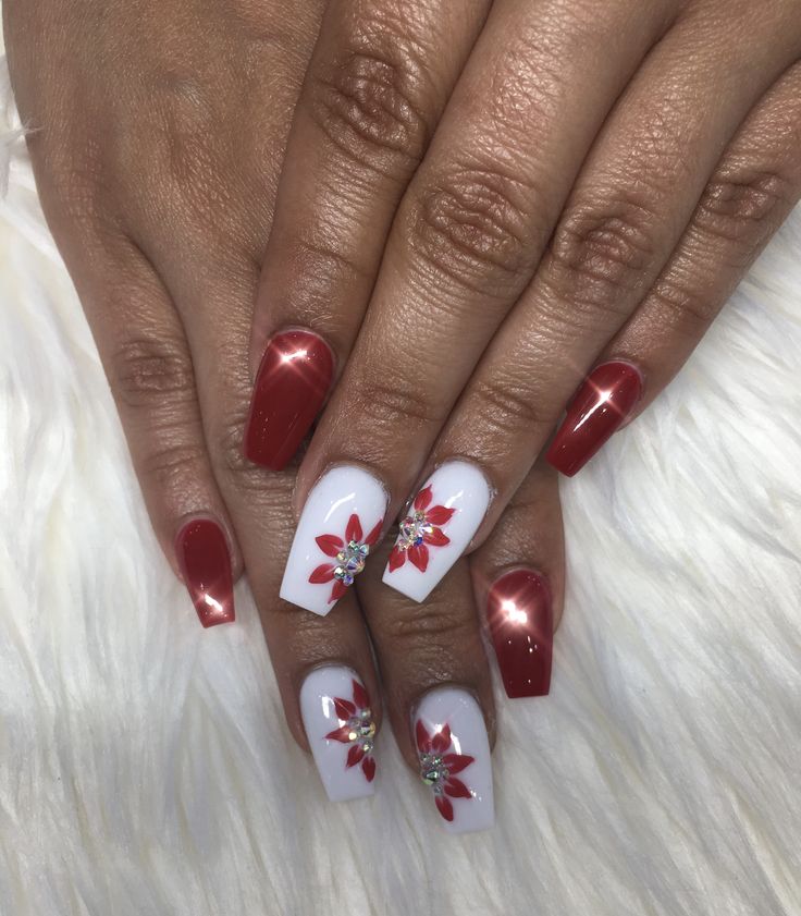 Sophisticated Festive Nail Design with Glossy Red, White Finishes, and Floral Accents.