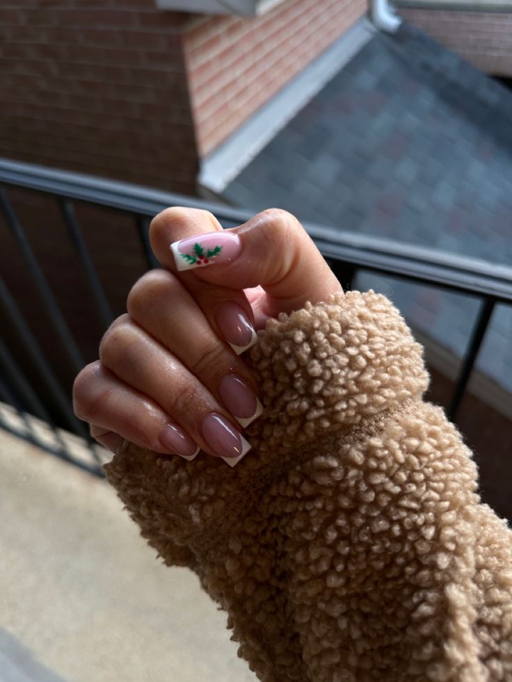 Sophisticated Soft Pink Nail Design with Floral Accent and French Tips for a Cozy Aesthetic.