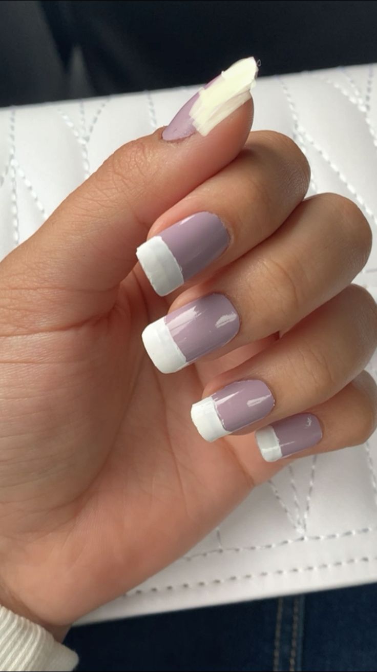 Modern Lavender French Manicure with Bold White Tips and Playful Nail Lengths.