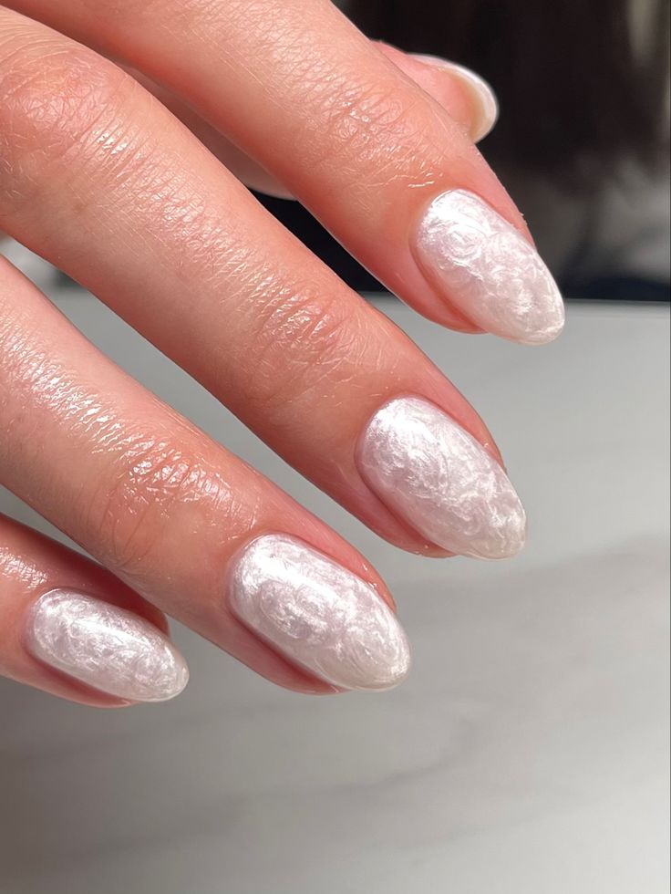 Sophisticated Textured White Nail Design with Glossy Finish and Almond Shape.