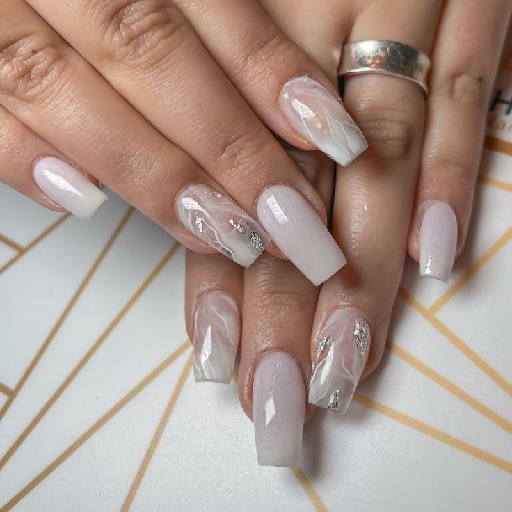 Sophisticated Ombre Nails with Shimmering Marble Patterns and Silver Accents