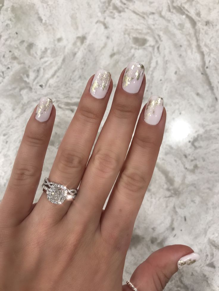 Sophisticated Soft Pink Nail Design with Delicate Gold Glitter Accents