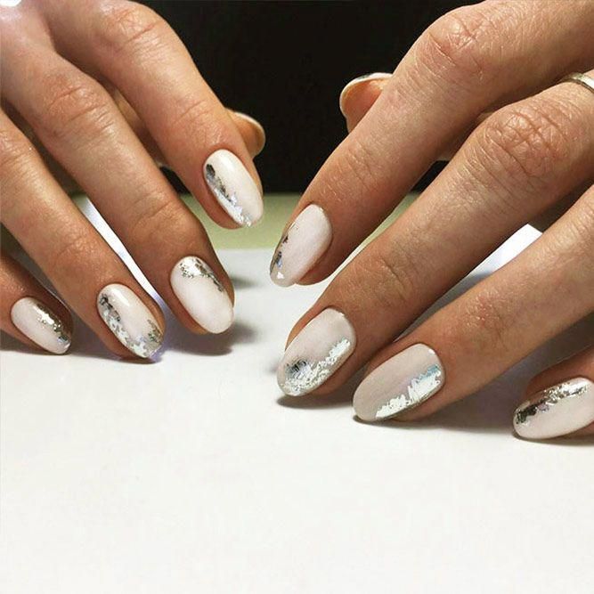 Sophisticated Almond Nail Design with Soft White and Sparkling Silver Accents