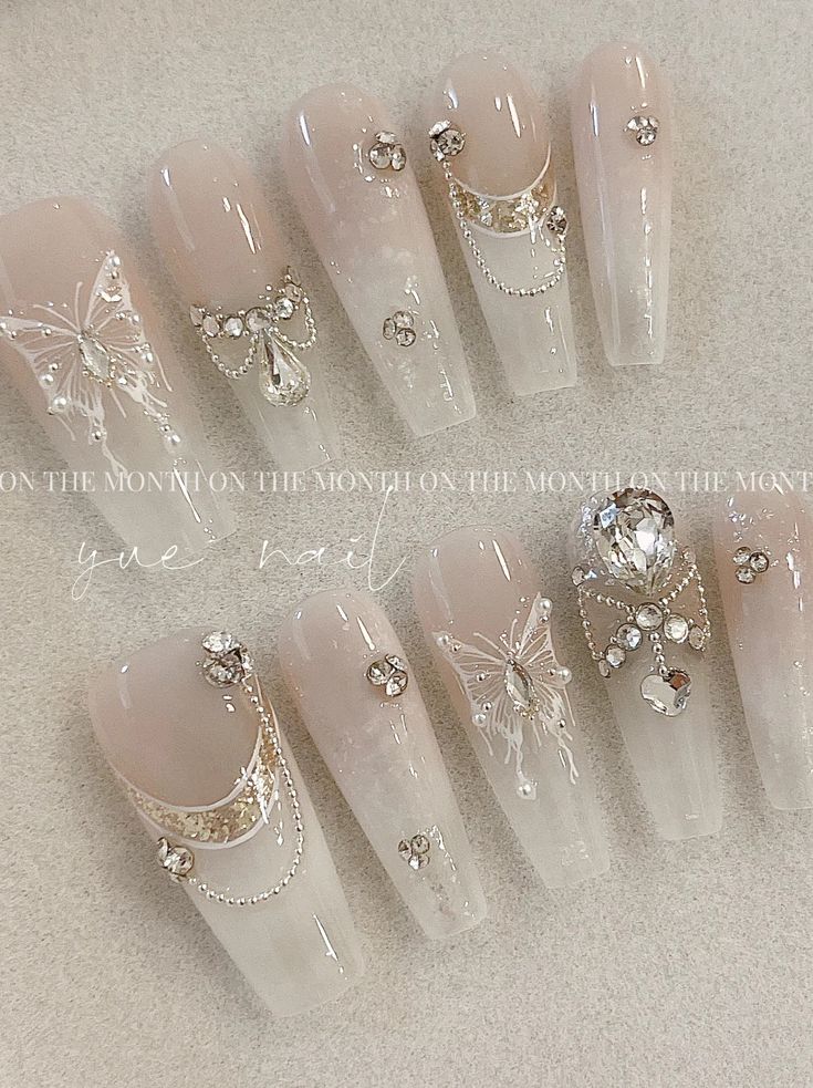 Sophisticated Nude Nail Design with Glossy Finish and Whimsical Embellishments