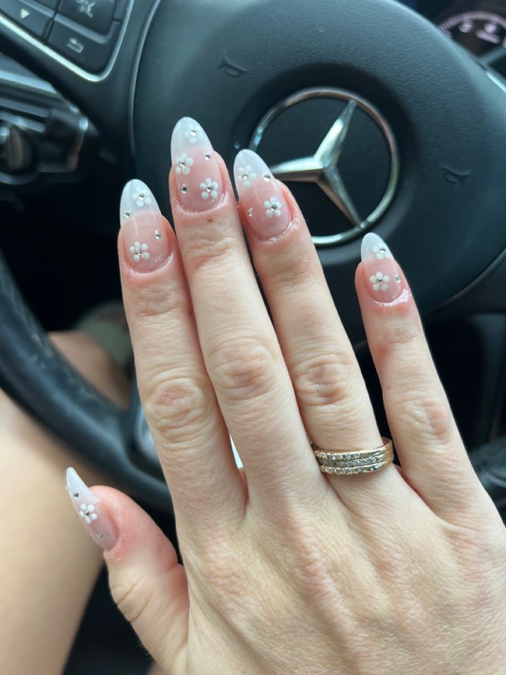 Sophisticated Almond-Shaped Nails with Sheer Pink Base and Floral Accents.