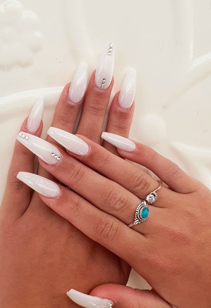 Chic Elegant Acrylic Nails with Shimmering White Polish and Glamorous Rhinestones