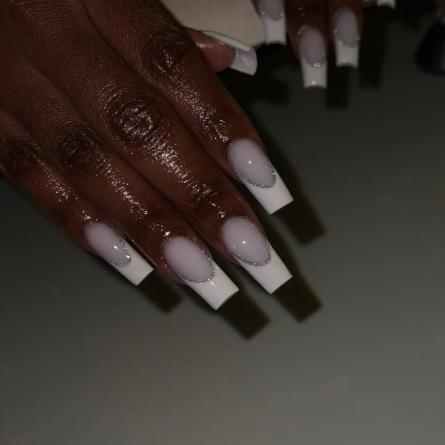 Elegant Ombre Nails: Soft Pink to Crisp White with Glamorous Silver Embellishments in a Stylish Square Shape.