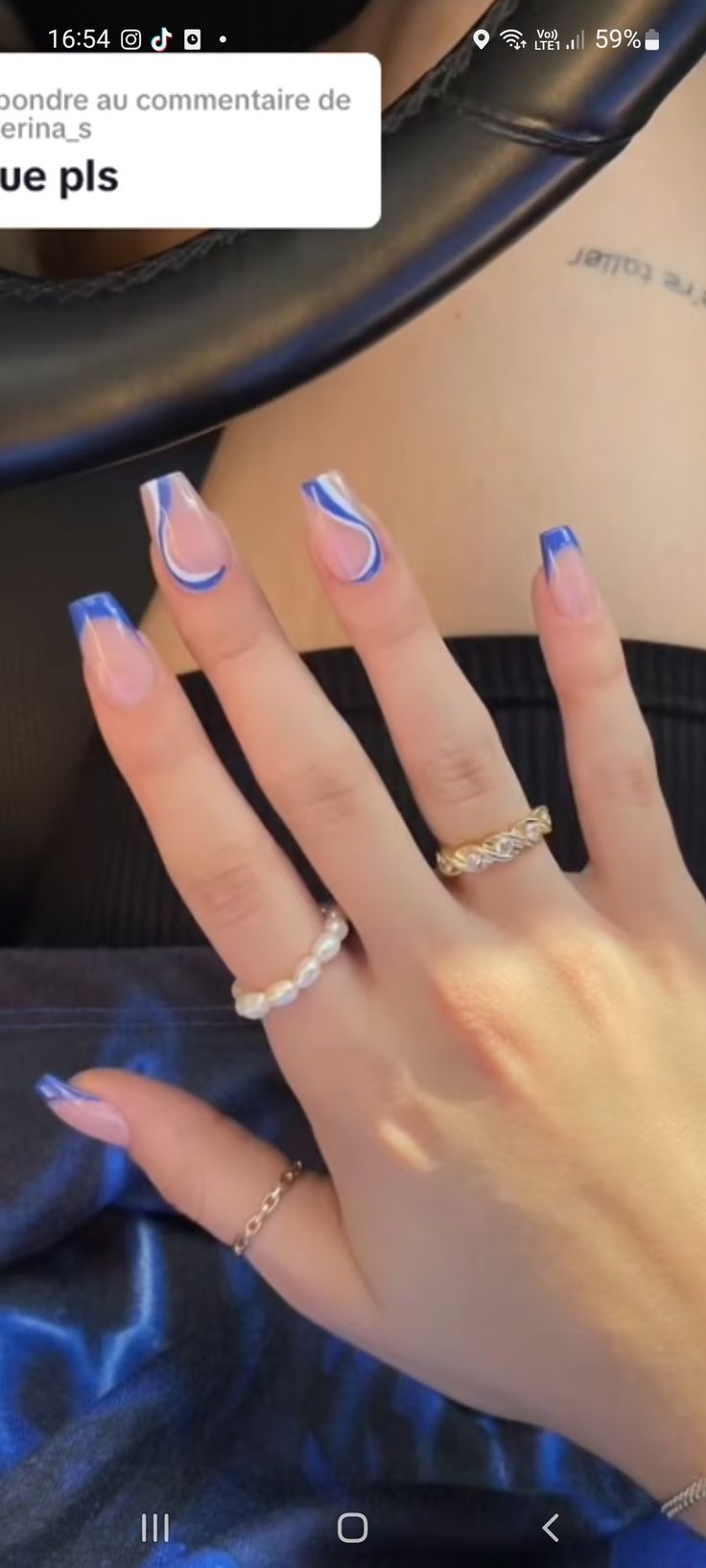 Elegant Wave Pattern Nail Design in Light Pink and Bold Blue.