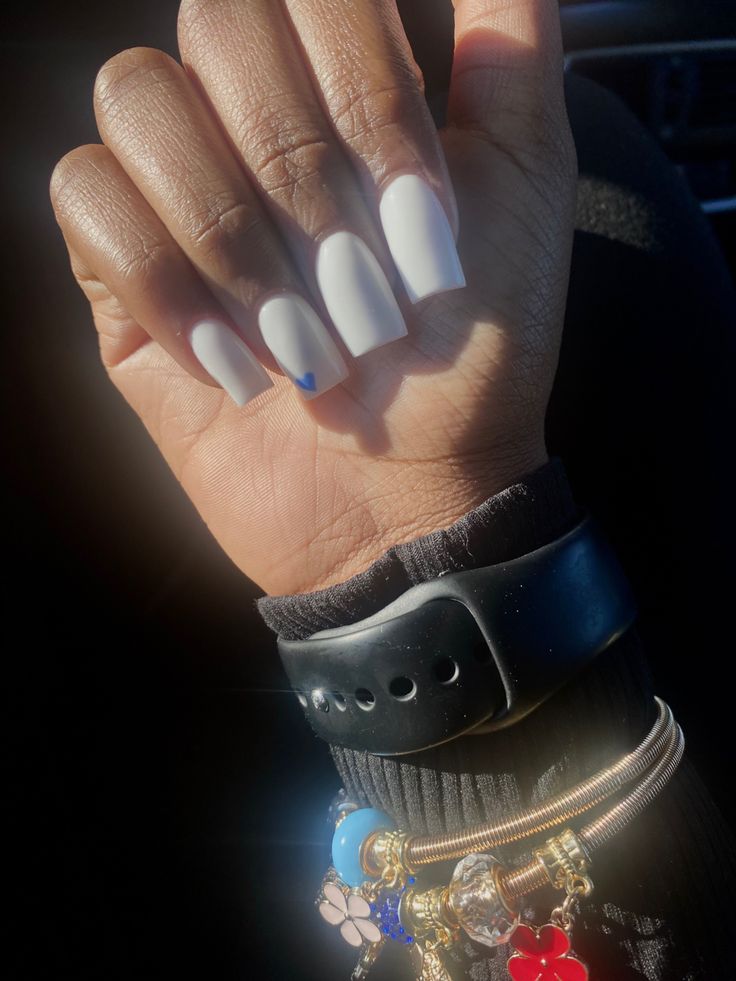 Sleek Chic White Manicure with Unique Blue Accent on Oval Nails.