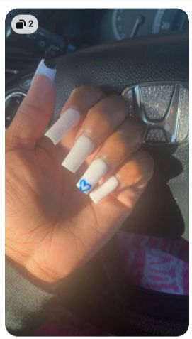 Chic White Long Nails with Playful Blue Heart Accent: A Sophisticated Statement Look.