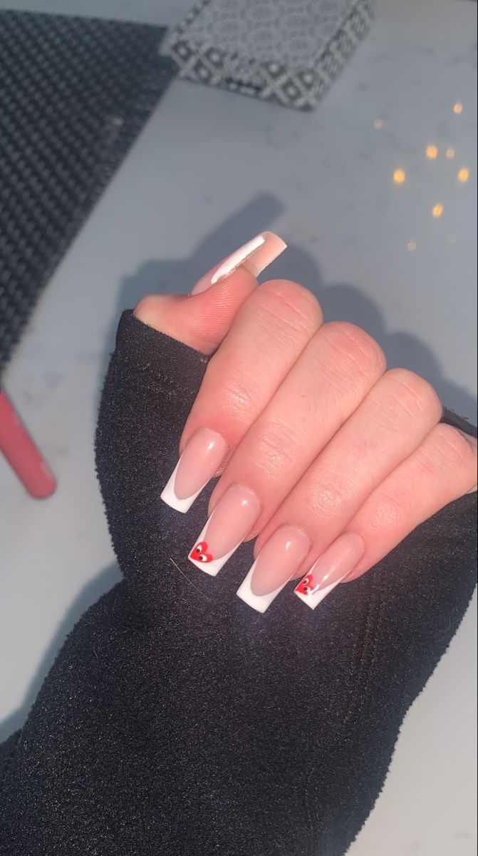 Timeless French Manicure with Playful Red Heart Accents on Elegant Square Tips.