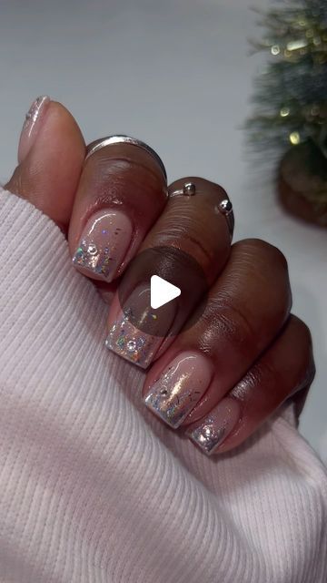 Elegant Nude Nail Design with Shimmering Silver Tips and Iridescent Accents.