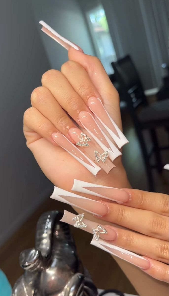 Chic Long Glossy Nails with White Geometric Patterns and Sparkling Butterfly Accents.