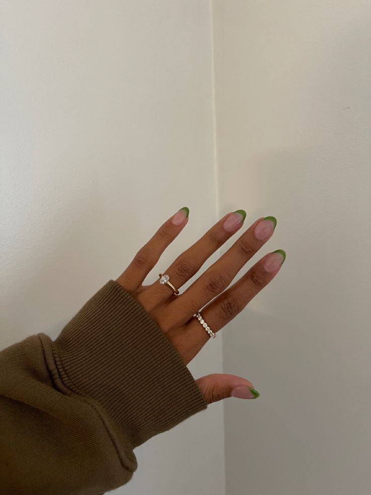 Chic Ombre Nail Design: Natural Base with Vibrant Green Tips and Elegant Ring Accents.