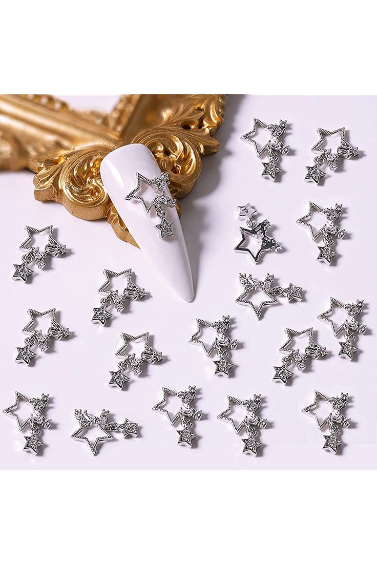 Whimsical Star-Shaped Nail Embellishments with Sparkling Silver Accents for a Trendy Look.