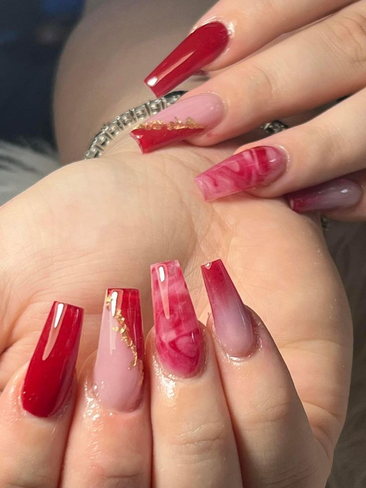 Sophisticated Bold Red and Soft Pink Gradient Nail Design with Glossy Finishes and Gold Accents.