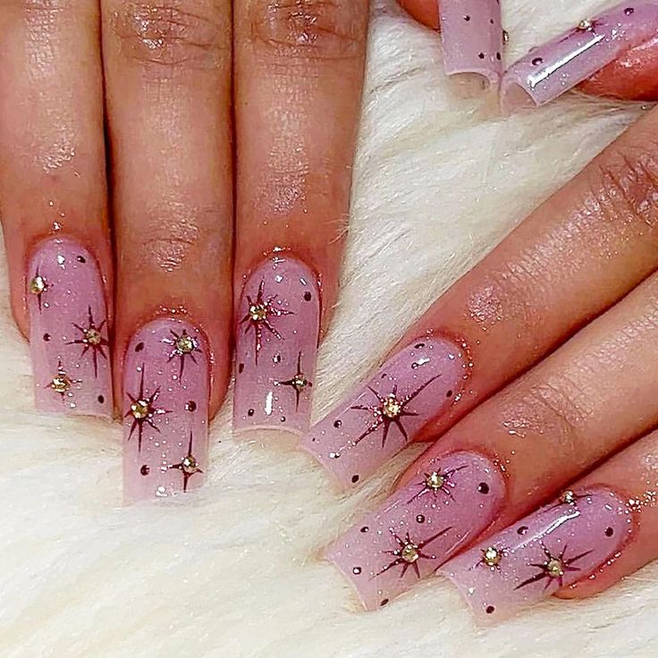 Whimsical Floral-Inspired Nail Design with Pink Ombre and Celestial Accents