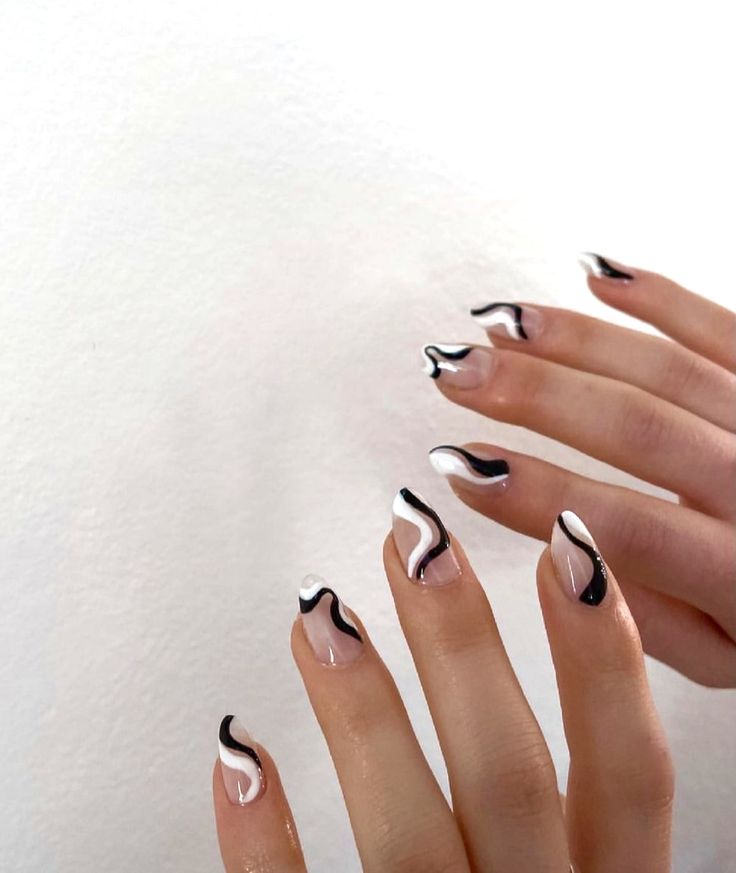 Elegant Black and White Swirl Nail Design: A Modern Take on Classic Simplicity.