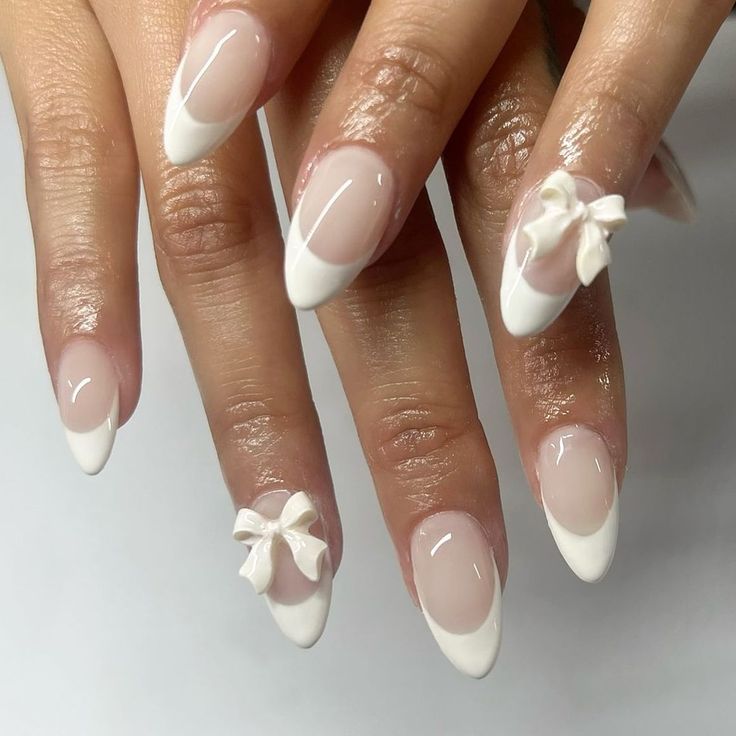 Charming Elegant French Tip Nails with Delicate Bows for Special Occasions.