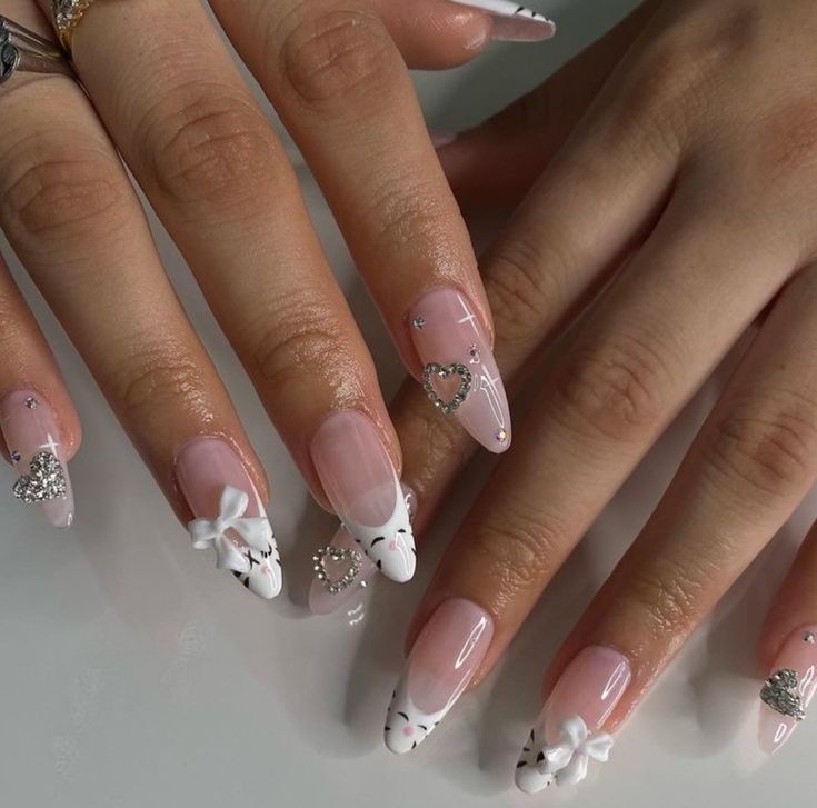 Chic Pink to White Gradient Nail Design with Heart and Bow Accents