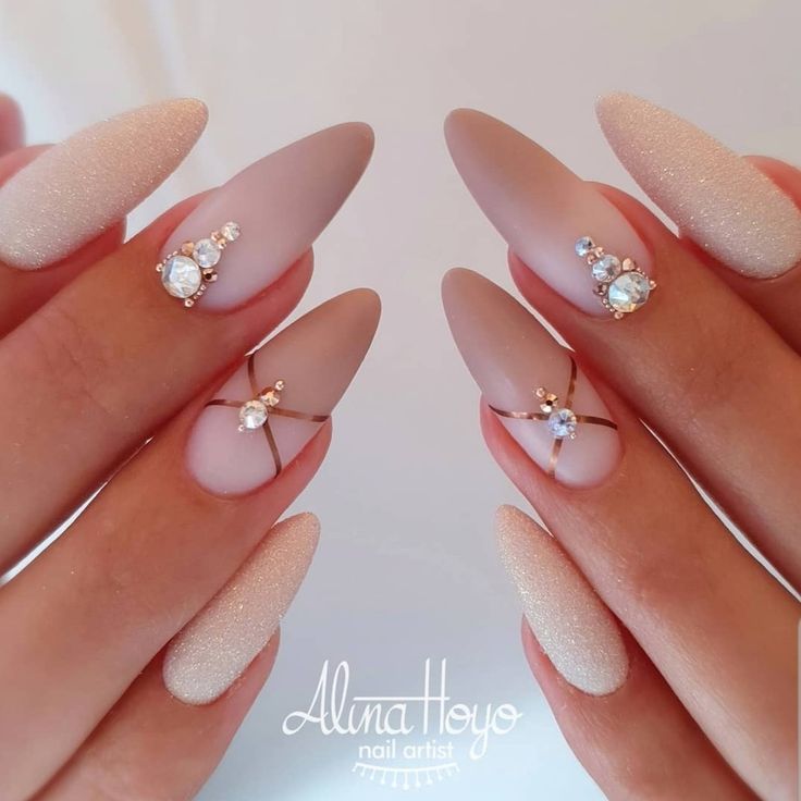 Chic Matte Nude and Shimmering Beige Nails with Rhinestone and Gold Accents