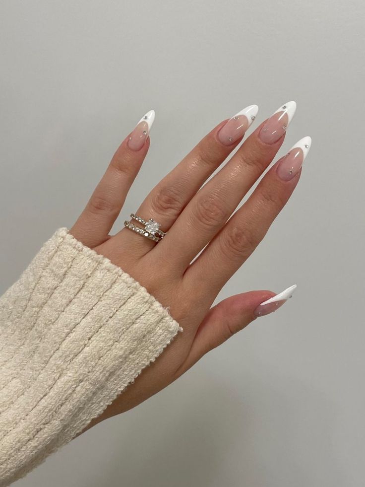 Chic Almond-Shaped Nails: Nude Base with White French Tips and Subtle Pink Undertones for Versatile Elegance.