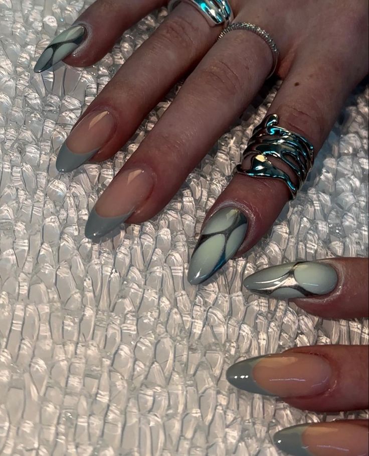 Elegant Pointed Tip Nail Design with Gray and Nude Shades and Intricate Patterns