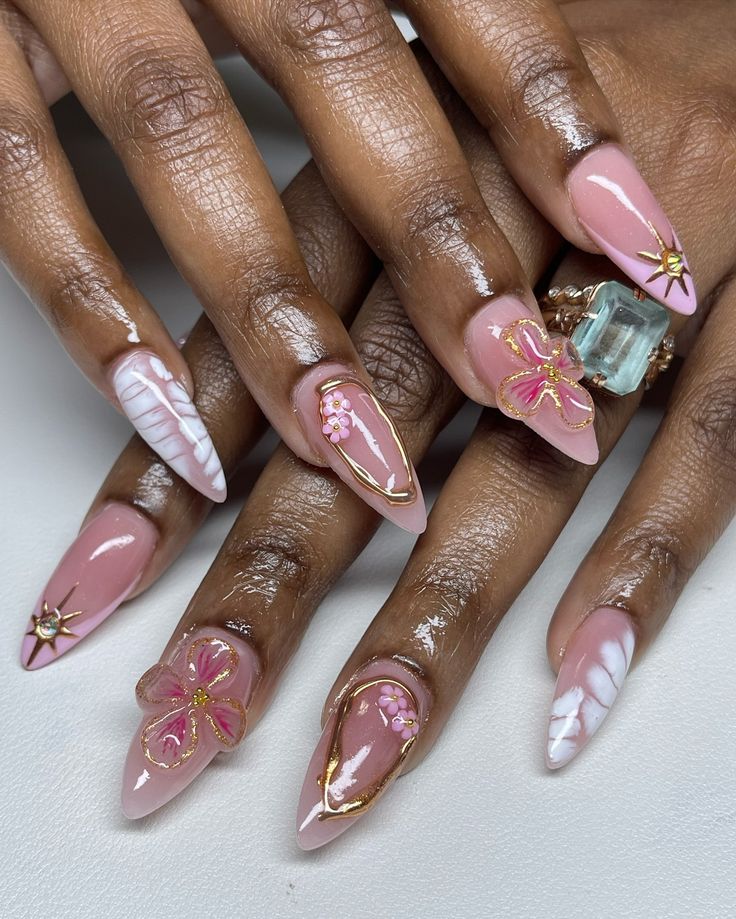 Charming Almond-Shaped Nail Design with Elegant Pink Tones and Floral Accents.