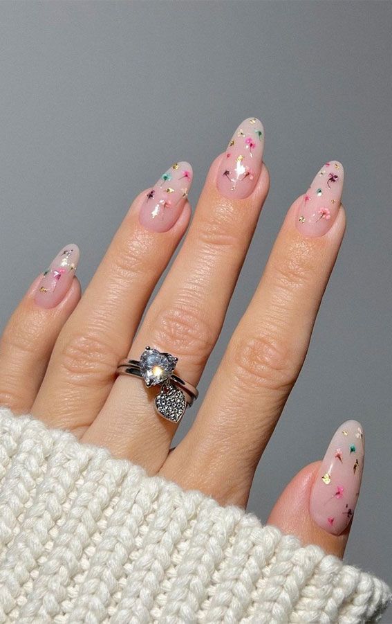 Chic Delicate Nail Design with Pastel Accents and Elegant Elongated Shape.