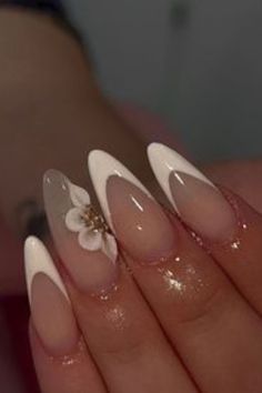 Sophisticated Almond-Shaped Nail Design with Clear and White Tones and Delicate Floral Accents.