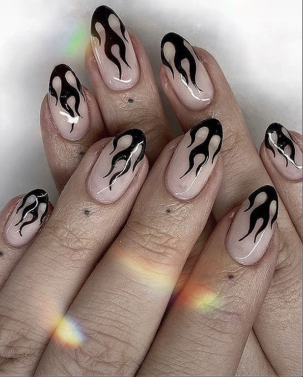 Flame-Inspired Nail Design: Bold Black Tips on Nude Bases for a Stylish Statement.