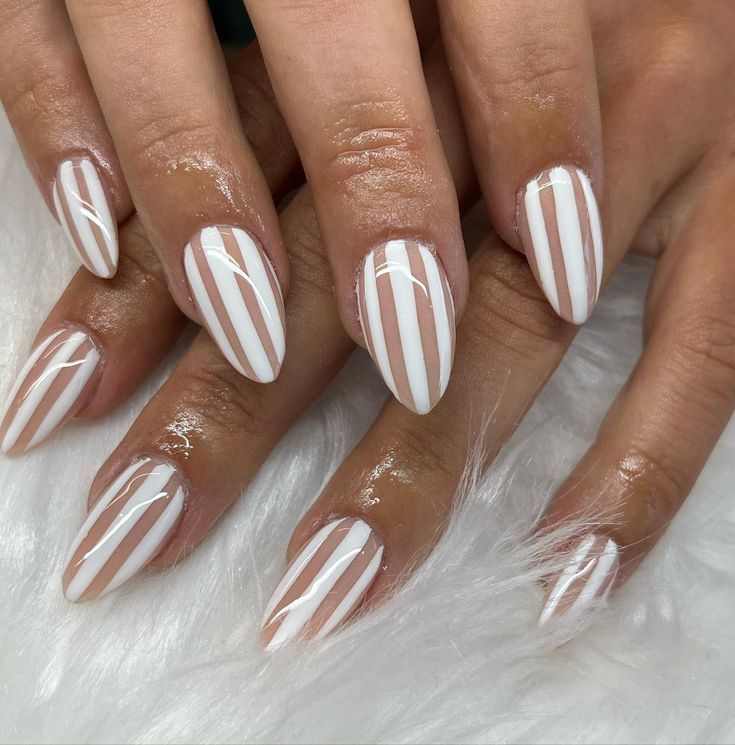 Chic Elongated Almond Nail Design with White Base and Bold Vertical Stripes