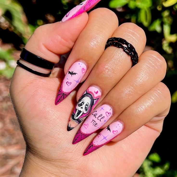 Bold Halloween Nail Art: Playful Stiletto Designs with Ghosts and Bats